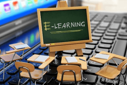 E-learning: a small classroom with a blackboard on a laptop keyboard